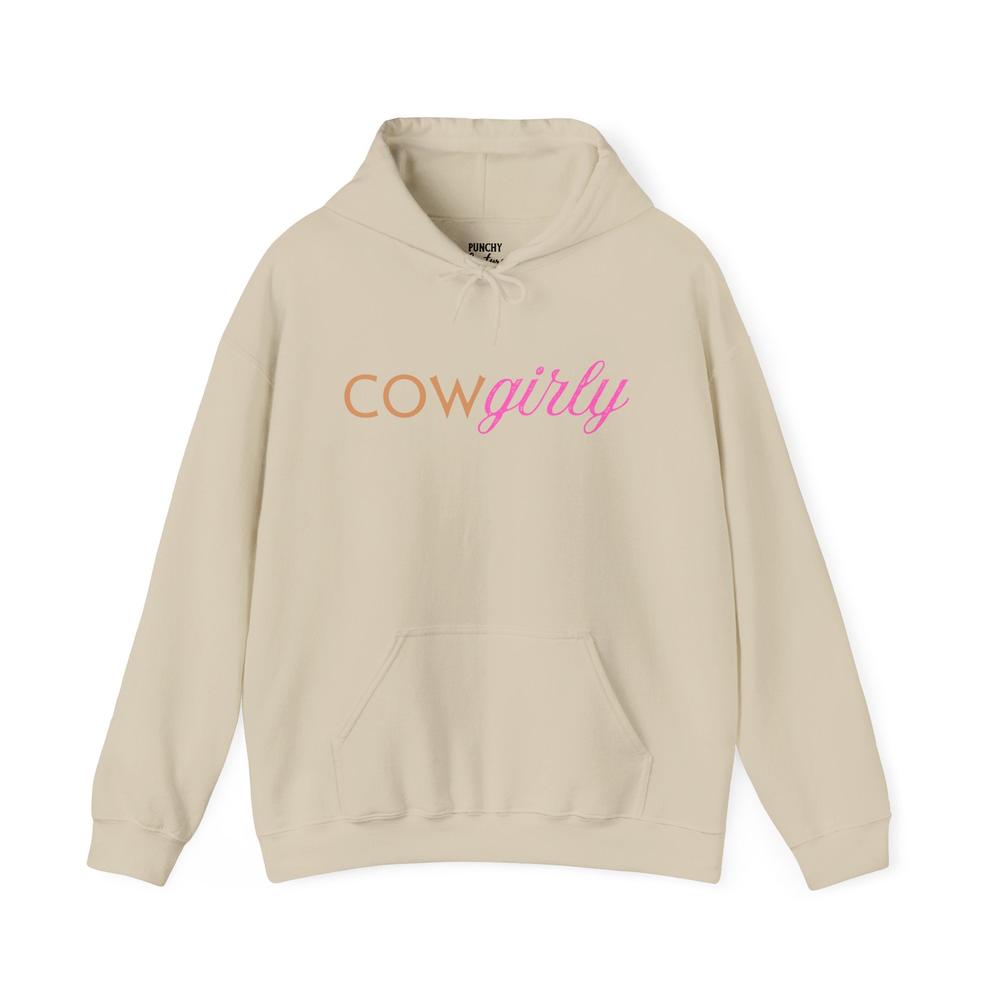 Beige hooded sweatshirt with orange block "COW" and pink cursive "girly" printed across the chest; cozy Western-inspired design blending rustic charm with feminine flair.