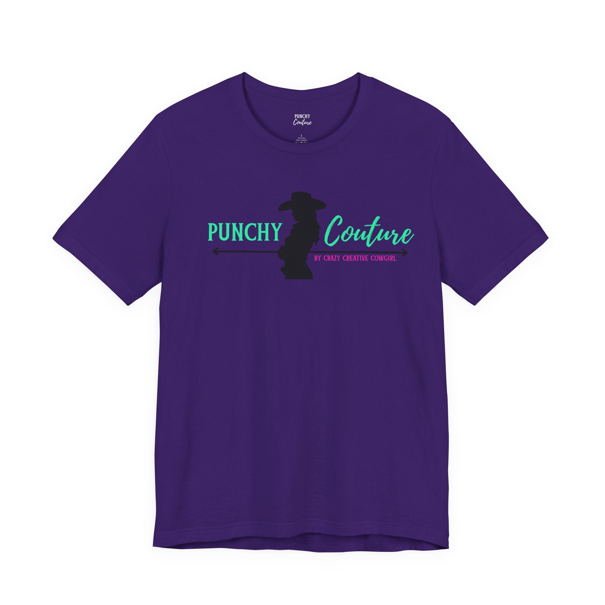 Purple t-shirt with silhouette of cowgirl holding a rope and bold green and turquoise “PUNCHY Couture” text; pink tagline reads “BY CRAZY CREATIVE COWGIRL”; Western graphic tee with mythic branding and bold feminine energy.
