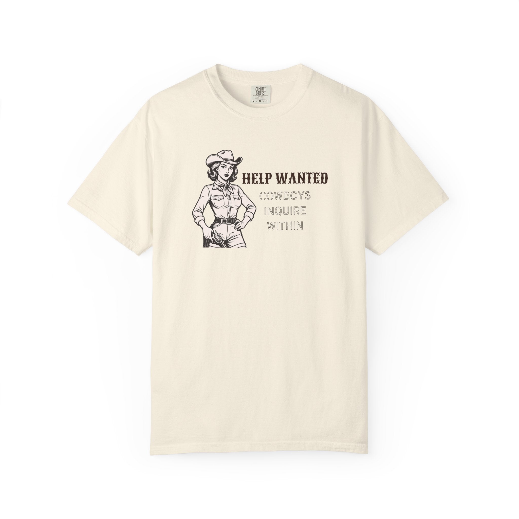 White t-shirt with vintage-style cowboy illustration and bold black text reading “HELP WANTED COWBOYS INQUIRE WITHIN”; Western graphic tee with retro charm and playful attitude.