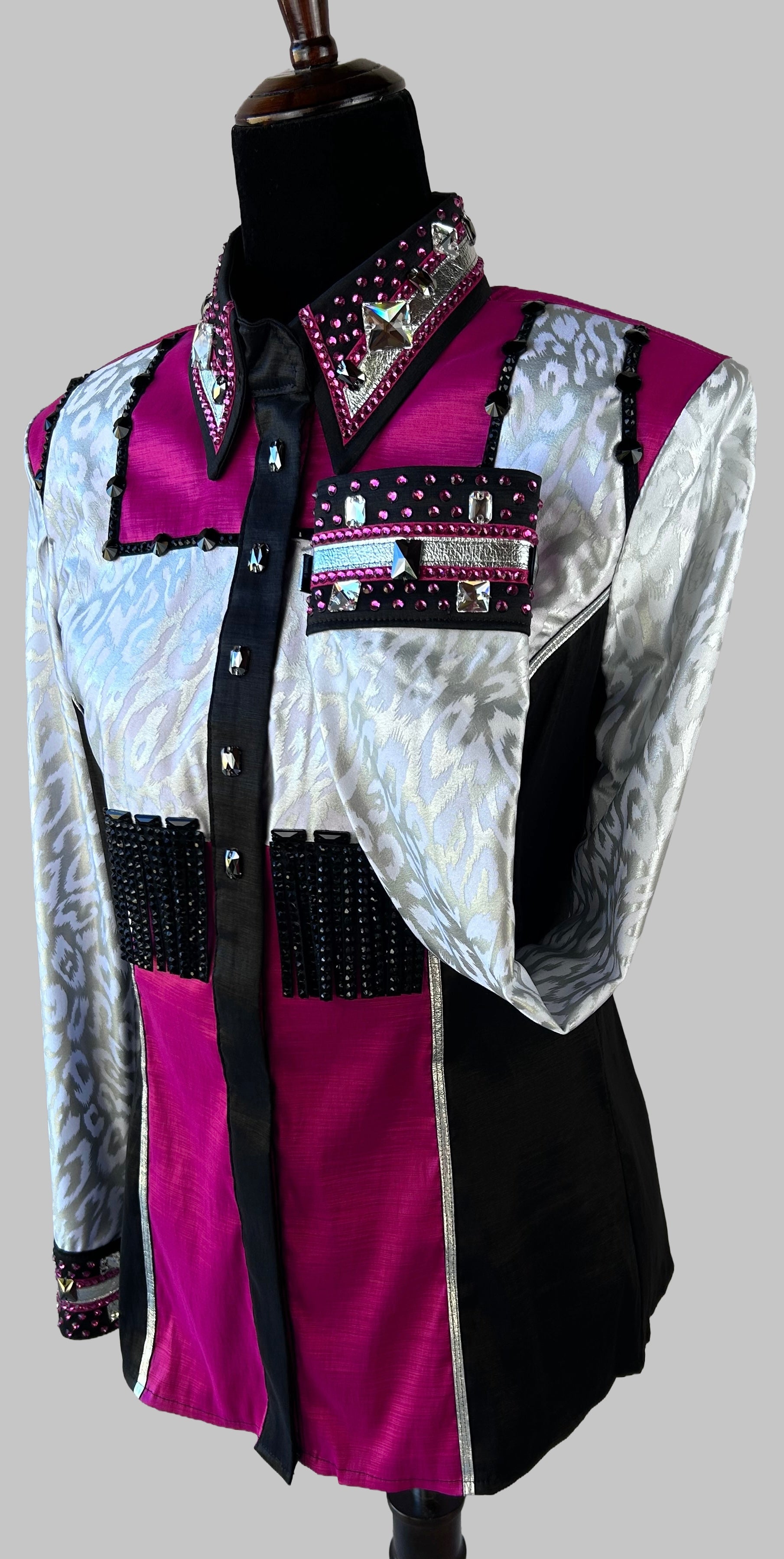Western-style performance shirt in magenta, black, and silver with ornate rhinestones, studs, and beaded accents; dramatic show-day design featuring jacquard textures, barbed embellishments, and couture-level craftsmanship.