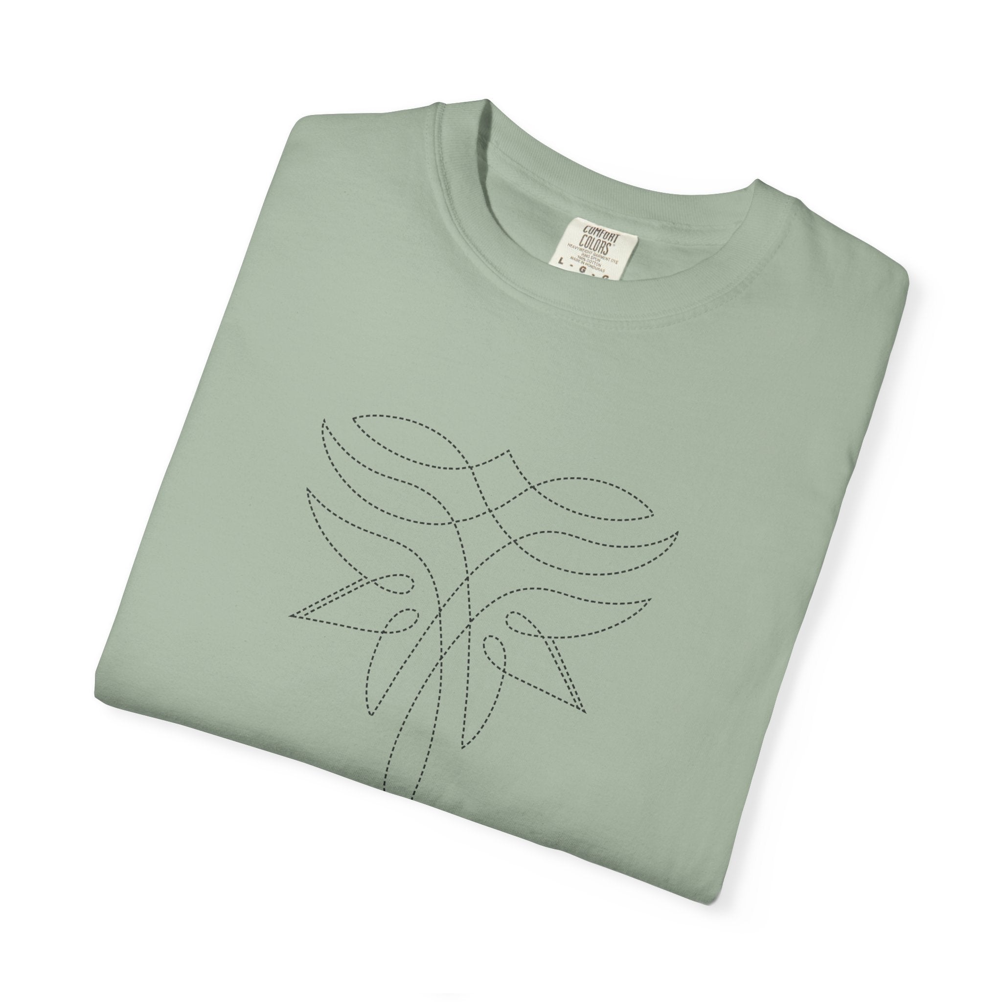 Folded light green t-shirt with minimalist black line art design featuring symmetrical curves and dotted accents; abstract Western motif with stitched elegance and soft grit.