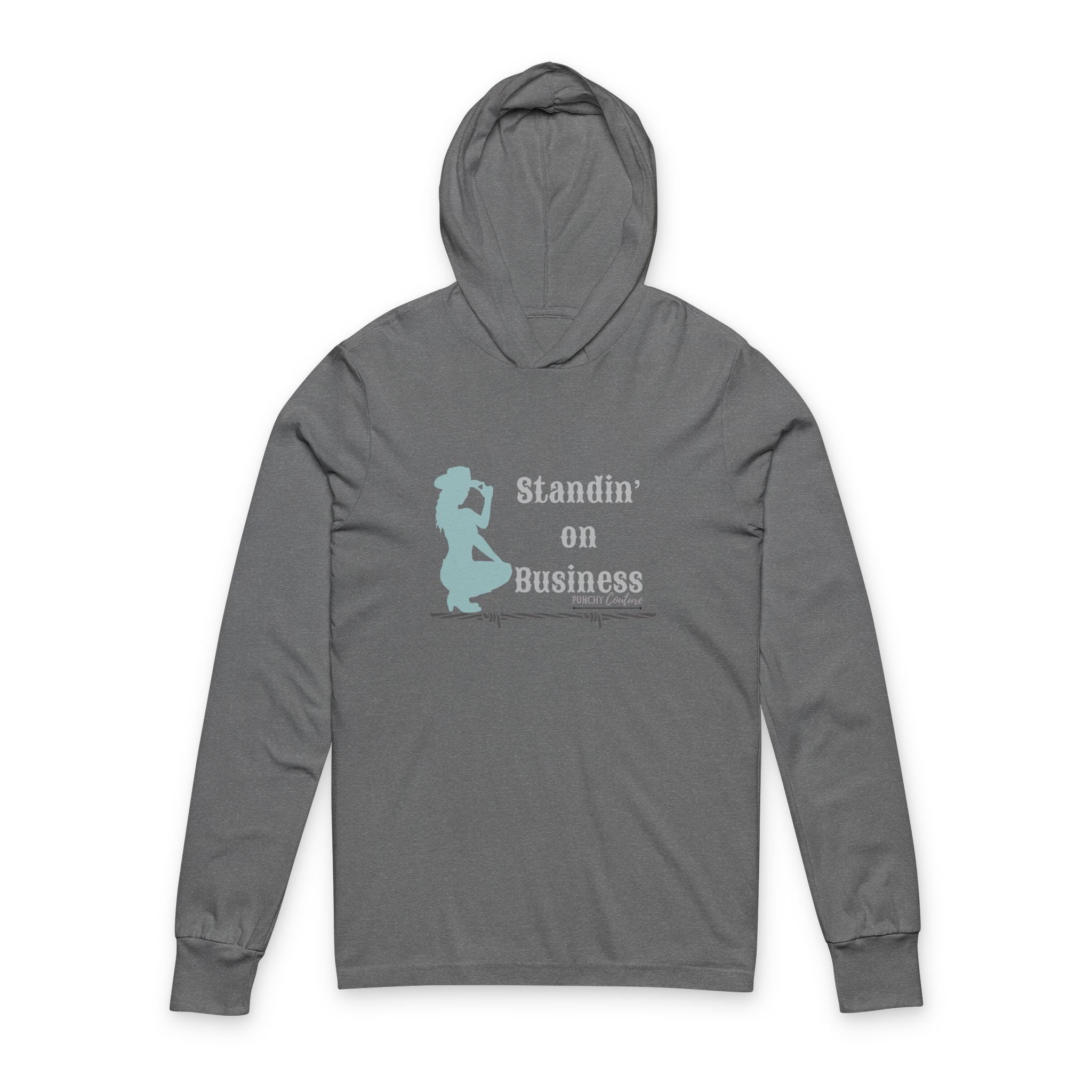 Gray hooded long-sleeve shirt with light blue silhouette of kneeling cowboy holding a drink, text reading “Standin’ on Business” with “Punchy Couture” branding, and barbed wire graphic below; rugged Western hoodie with bold attitude.